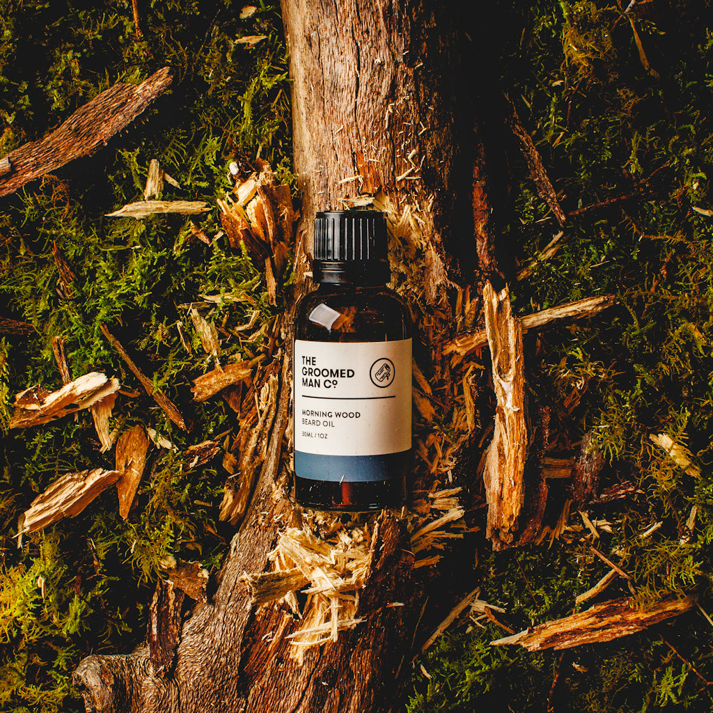 The Groomed Man Co. Morning Wood Premium Beard Oil on Top of Broken Tree Trunk