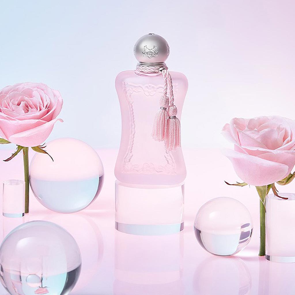Delina La Rosée by Parfums de Marly, 75ml soft pink bottle styled with pink roses and glass spheres