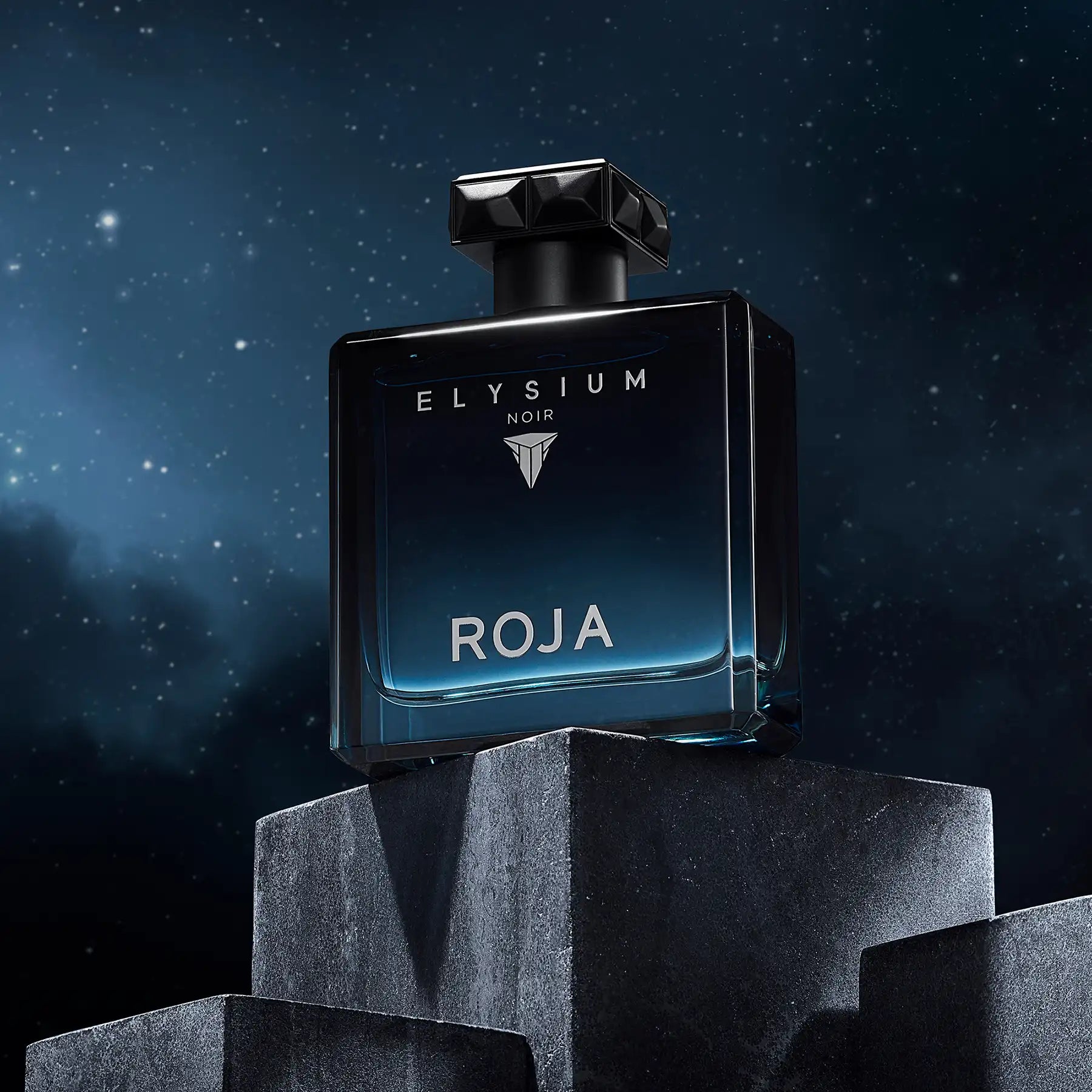 Roja Elysium Noir perfume bottle displayed on geometric stone blocks against a starry night sky backdrop