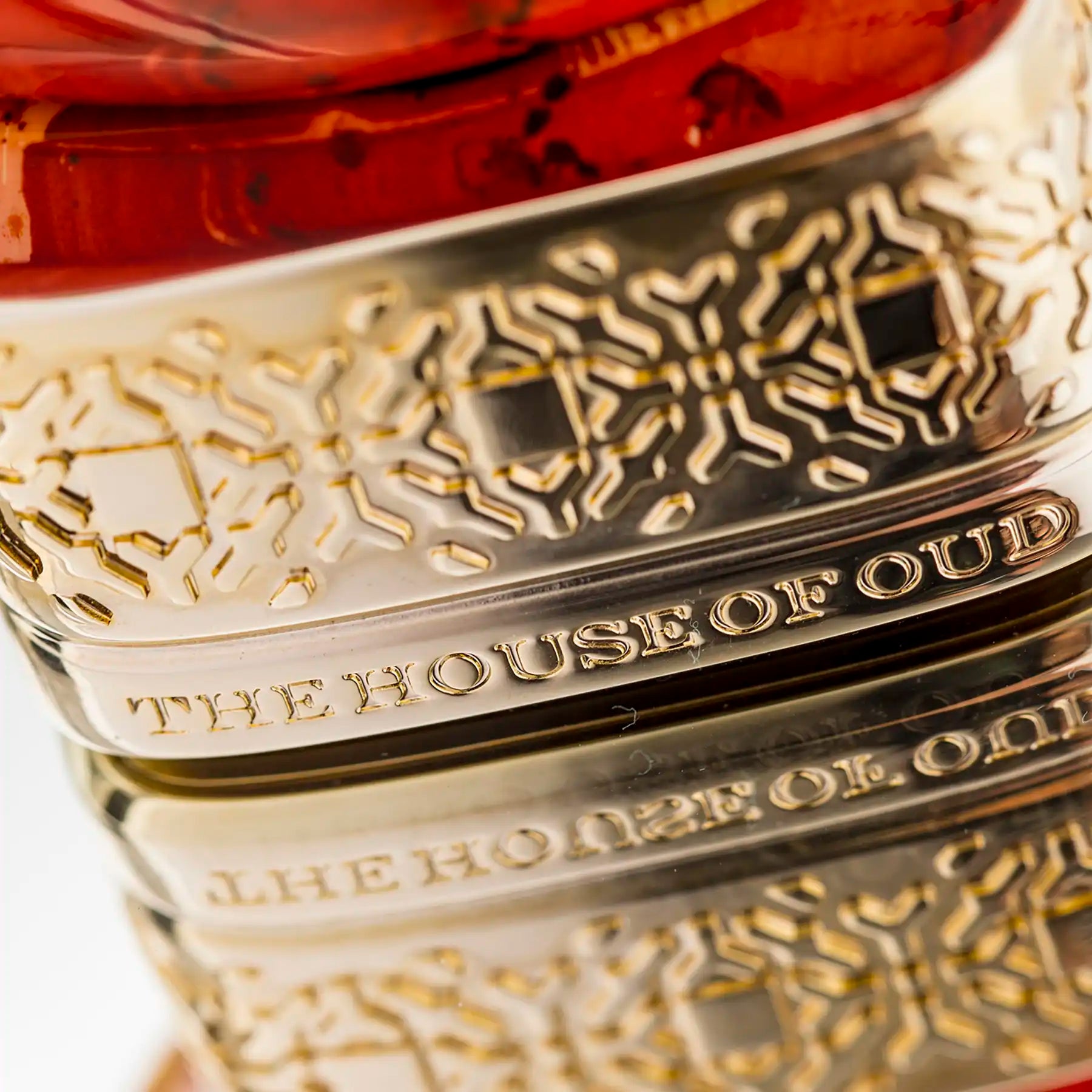 Close-up of intricate gold base on Almond Harmony Eau de Parfum bottle by The House of Oud