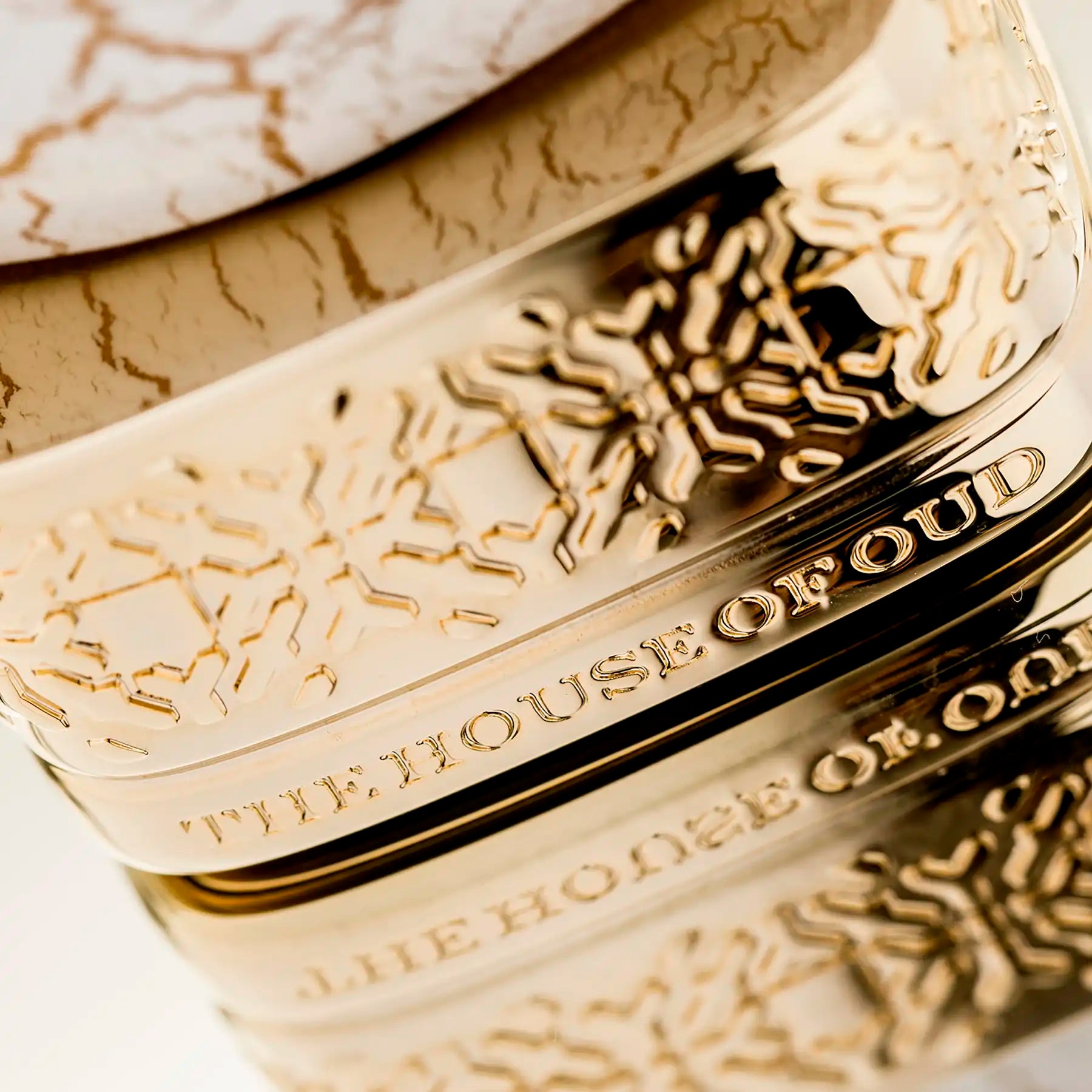 Close-up of intricate gold base on Breath of The Infinite Eau de Parfum bottle by The House of Oud.